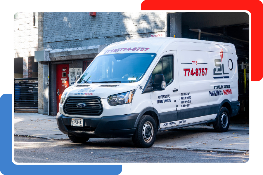 A white service van with company logos parked on a city street in front of a gray brick building.